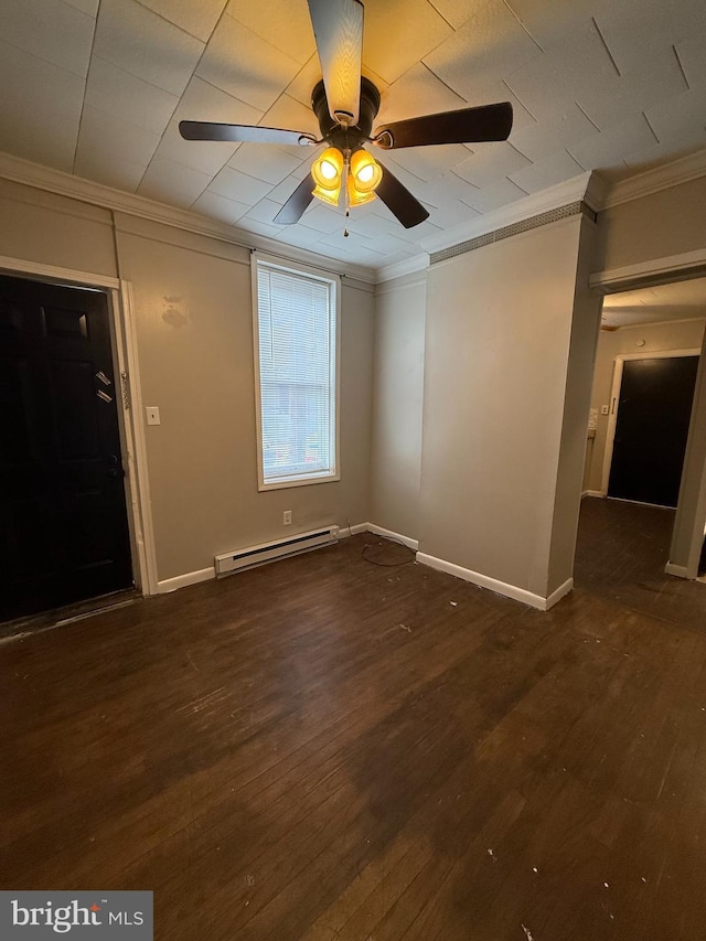 empty room featuring ornamental molding, dark hardwood / wood-style flooring, ceiling fan, and a baseboard heating unit