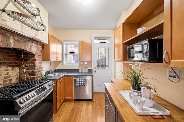 kitchen featuring butcher block countertops, light hardwood / wood-style floors, sink, and stainless steel appliances