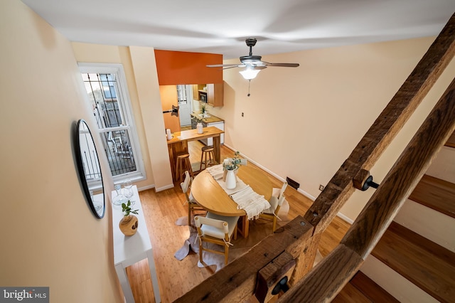 dining area with hardwood / wood-style floors and ceiling fan