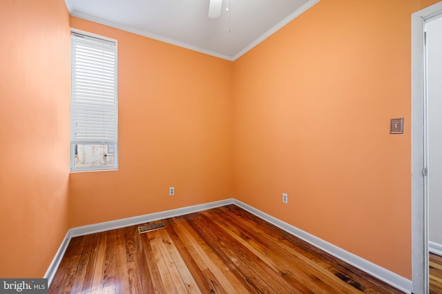 spare room with wood-type flooring, ceiling fan, and ornamental molding