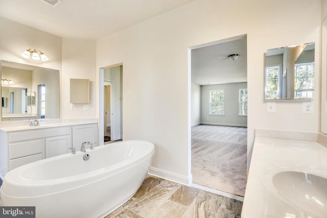 bathroom featuring vanity and a tub