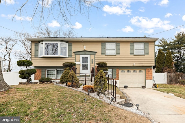 bi-level home featuring a front lawn and a garage