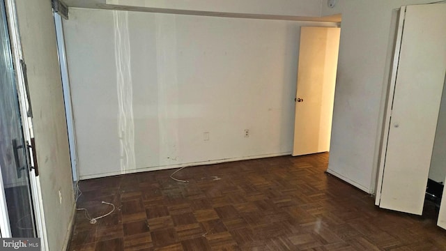 unfurnished room with dark parquet floors