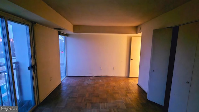 hallway with dark parquet flooring