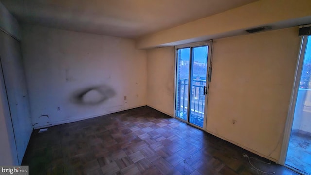 empty room featuring dark parquet flooring