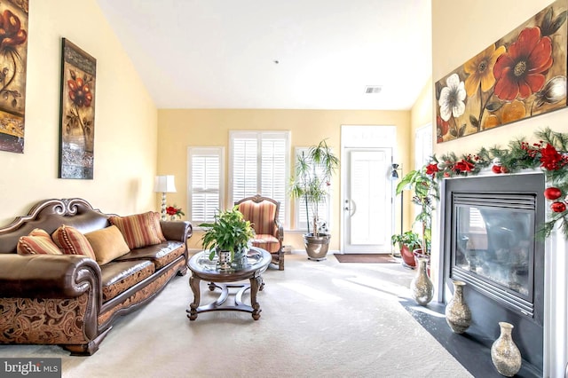 living room with carpet floors and vaulted ceiling