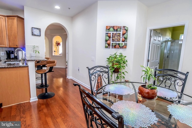 dining room featuring dark hardwood / wood-style flooring and sink