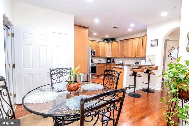 dining room featuring light hardwood / wood-style floors and sink