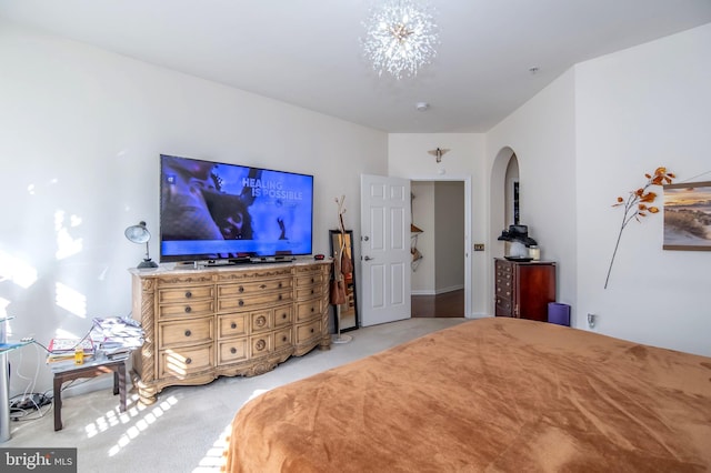 carpeted bedroom featuring a chandelier