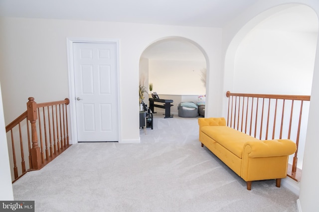 sitting room featuring light colored carpet