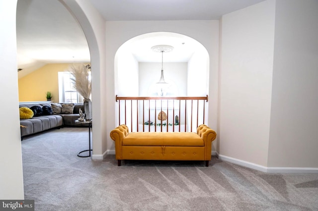 sitting room featuring carpet and lofted ceiling