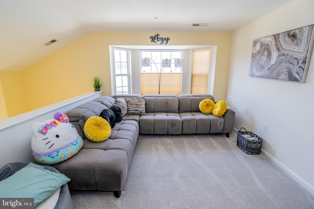 living room featuring light colored carpet and vaulted ceiling