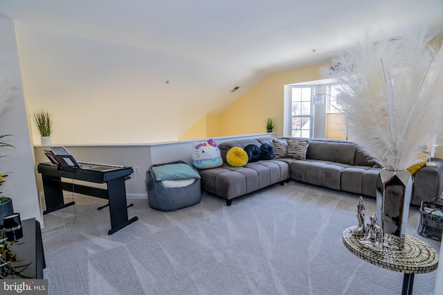 living room featuring light colored carpet and vaulted ceiling