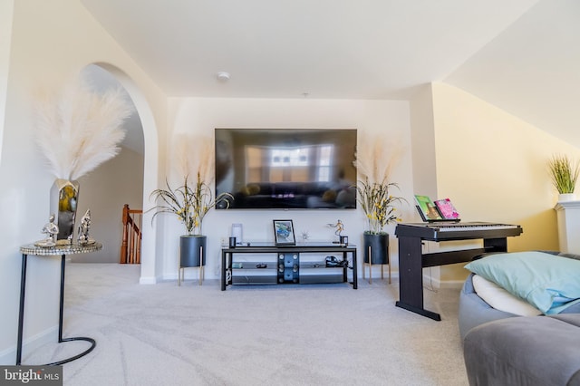 carpeted living room with vaulted ceiling