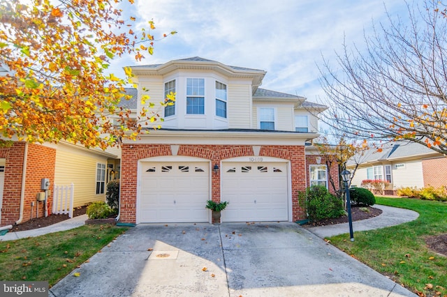 view of front of property featuring a garage and a front lawn