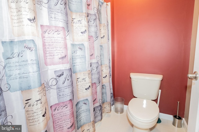 bathroom with tile patterned flooring and toilet