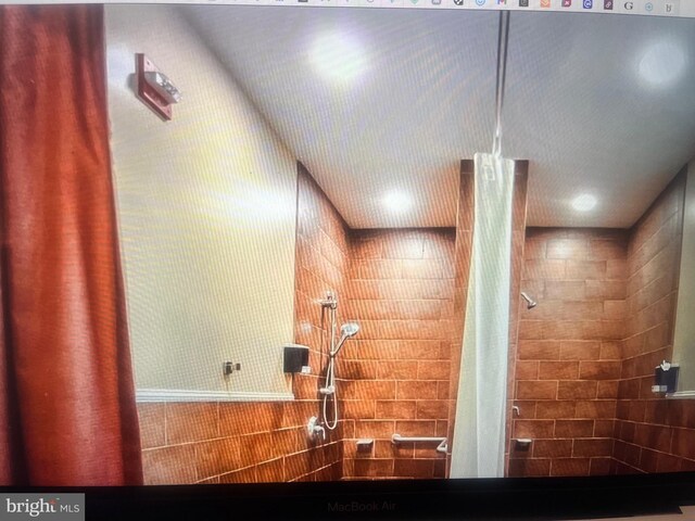 bathroom with a shower with shower curtain