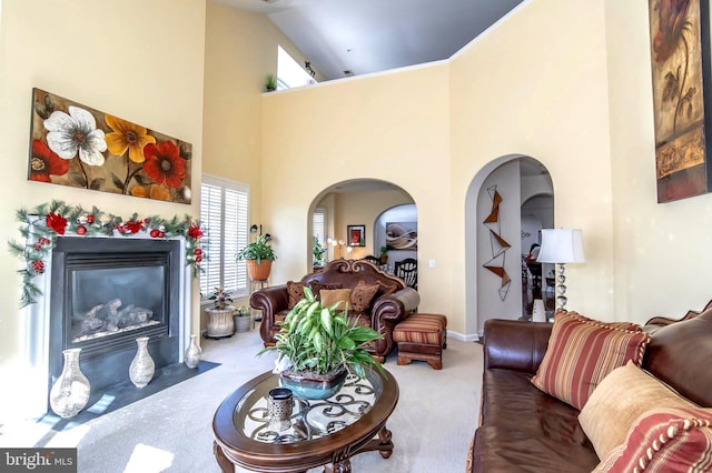 carpeted living room featuring high vaulted ceiling