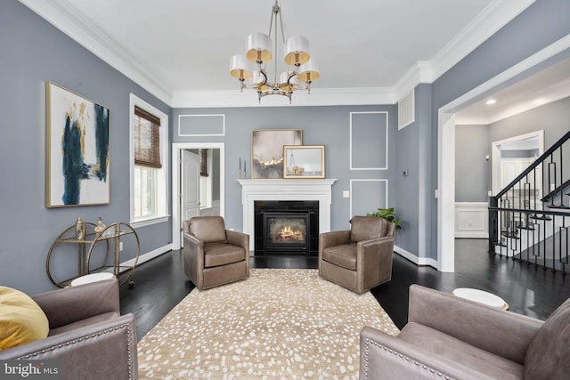 living room featuring a notable chandelier, dark hardwood / wood-style floors, and crown molding