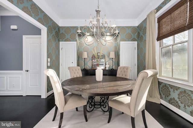 dining space with plenty of natural light, dark hardwood / wood-style floors, a notable chandelier, and ornamental molding