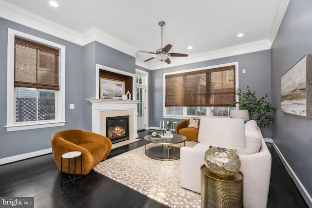 living room with dark hardwood / wood-style floors, ceiling fan, and crown molding