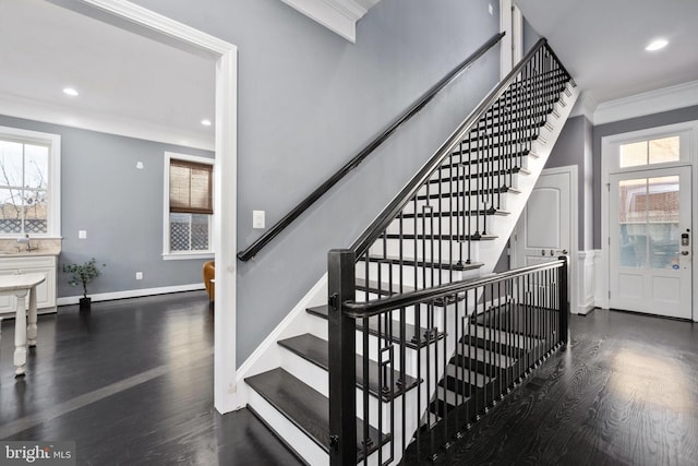 stairway featuring wood-type flooring and ornamental molding