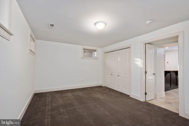 unfurnished bedroom featuring carpet and a closet