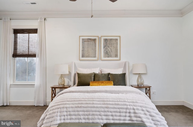 carpeted bedroom with ceiling fan and crown molding