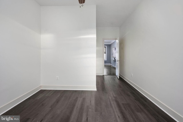 empty room featuring ceiling fan and dark wood-type flooring