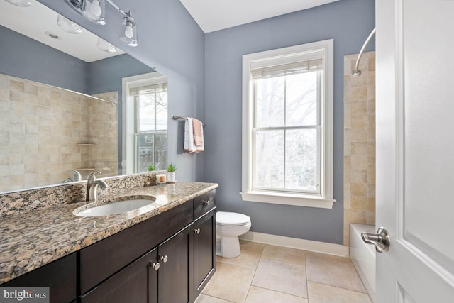 full bathroom with tile patterned flooring, vanity, toilet, and tiled shower / bath combo