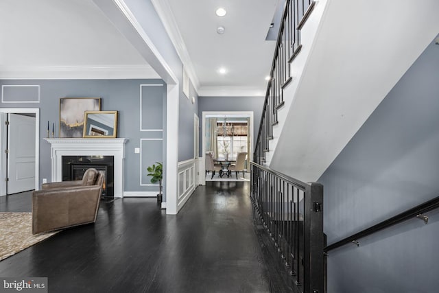 foyer featuring crown molding and dark wood-type flooring