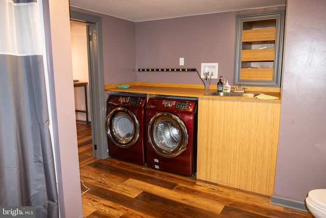 laundry room featuring separate washer and dryer, sink, and dark hardwood / wood-style floors