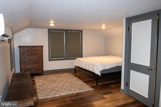 bedroom featuring dark wood-type flooring and lofted ceiling