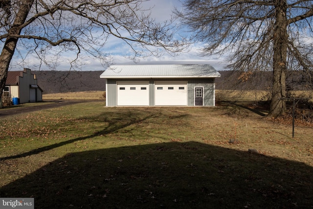 garage featuring a lawn