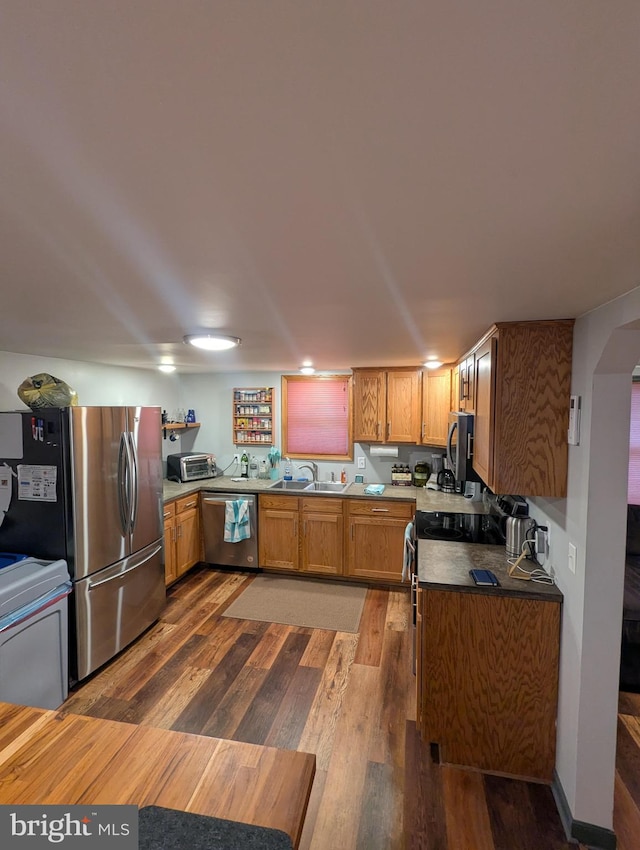 kitchen with hardwood / wood-style flooring, sink, and appliances with stainless steel finishes