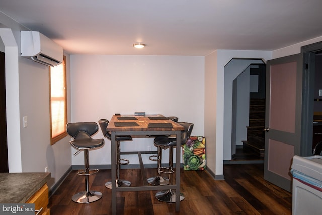 dining room with dark hardwood / wood-style floors and a wall unit AC