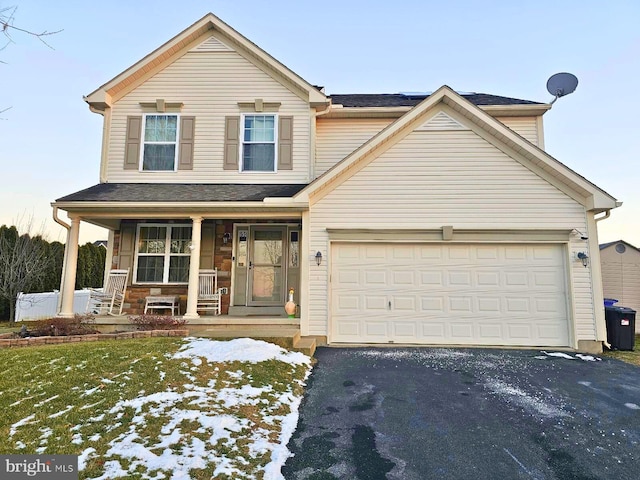 view of front of property with covered porch and a garage