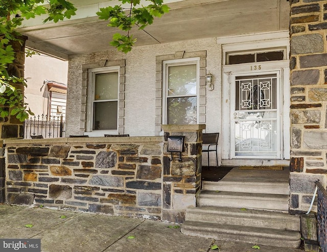 doorway to property featuring a porch