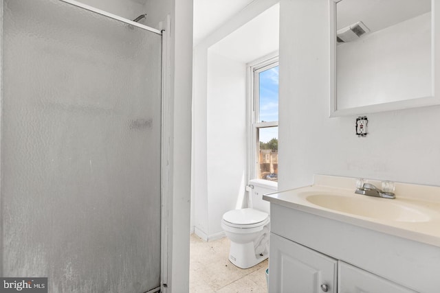 bathroom featuring vanity, an enclosed shower, and toilet