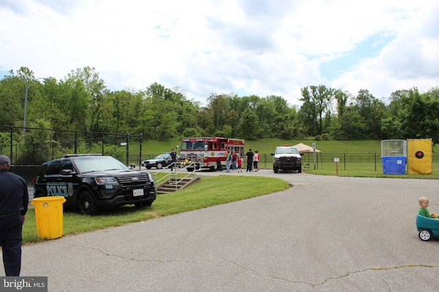 view of parking featuring a yard