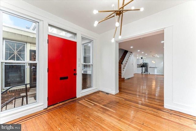 entrance foyer featuring an inviting chandelier and hardwood / wood-style flooring