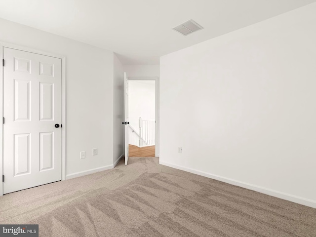 unfurnished bedroom featuring light colored carpet