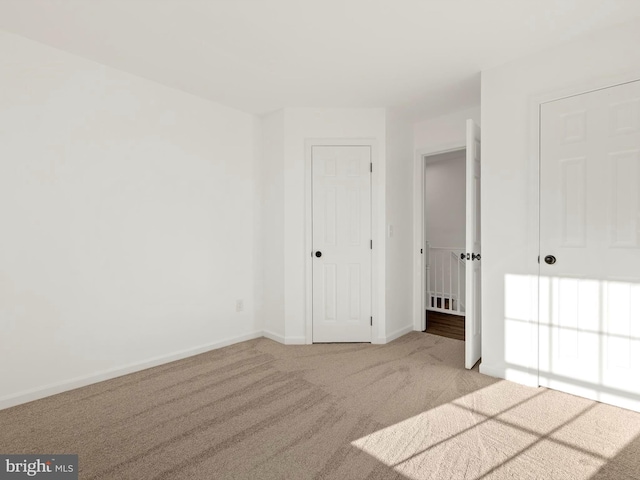 unfurnished bedroom with light carpet