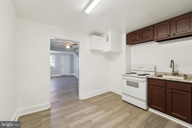 kitchen featuring dark brown cabinets, ceiling fan, sink, white electric range, and light hardwood / wood-style floors