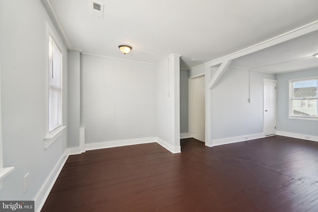 unfurnished room featuring dark wood-type flooring