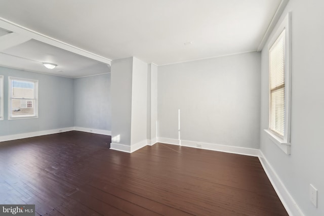 empty room featuring dark hardwood / wood-style flooring