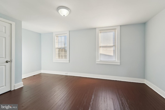 unfurnished room with dark hardwood / wood-style floors