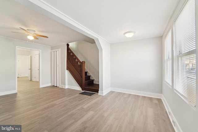 spare room with ceiling fan, plenty of natural light, and light hardwood / wood-style flooring