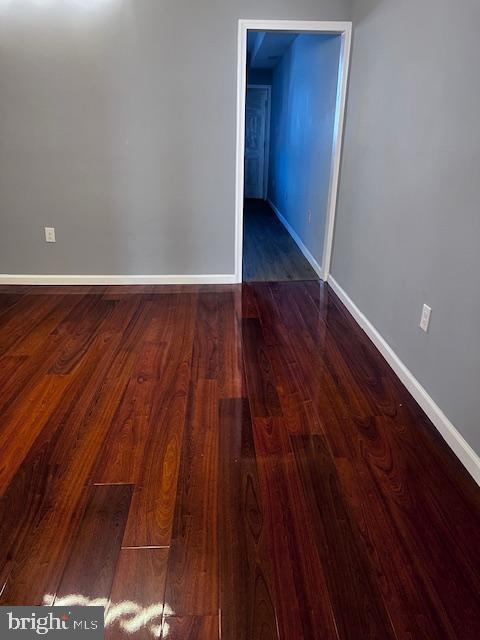 unfurnished room featuring dark hardwood / wood-style floors