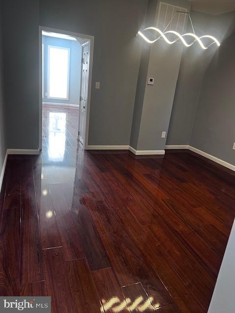 spare room with dark hardwood / wood-style floors